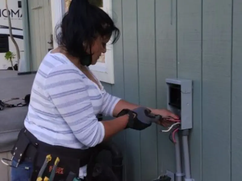 Licensed electrician wiring an exterior subpanel in Boaz